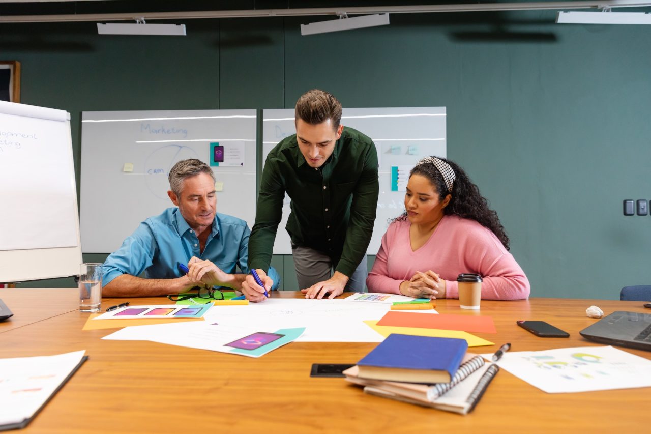 multiracial-businessmen-and-businesswoman-discussing-business-strategy-in-meeting-at-creative-office.jpg